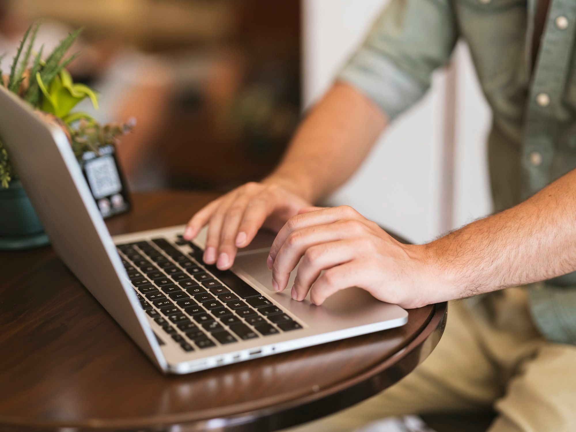 Business owner working through numbers on a laptop at a table