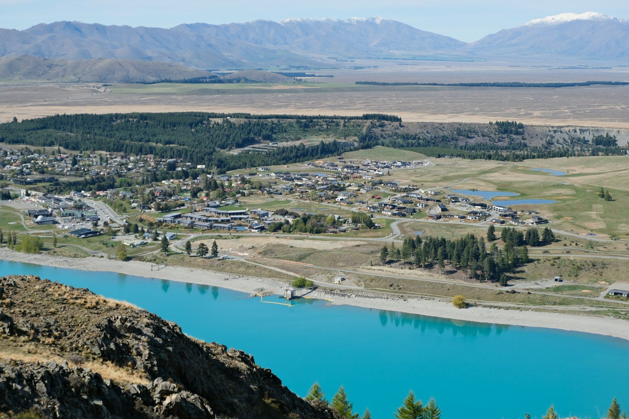 Tekapo township beside the glacial blue lake with mountains beyond